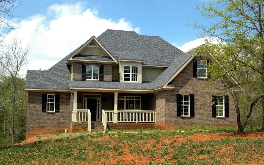Double-story house with gray roof and brown exterior