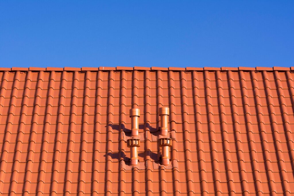 red rooftop with clear blue sky in the backdrop
