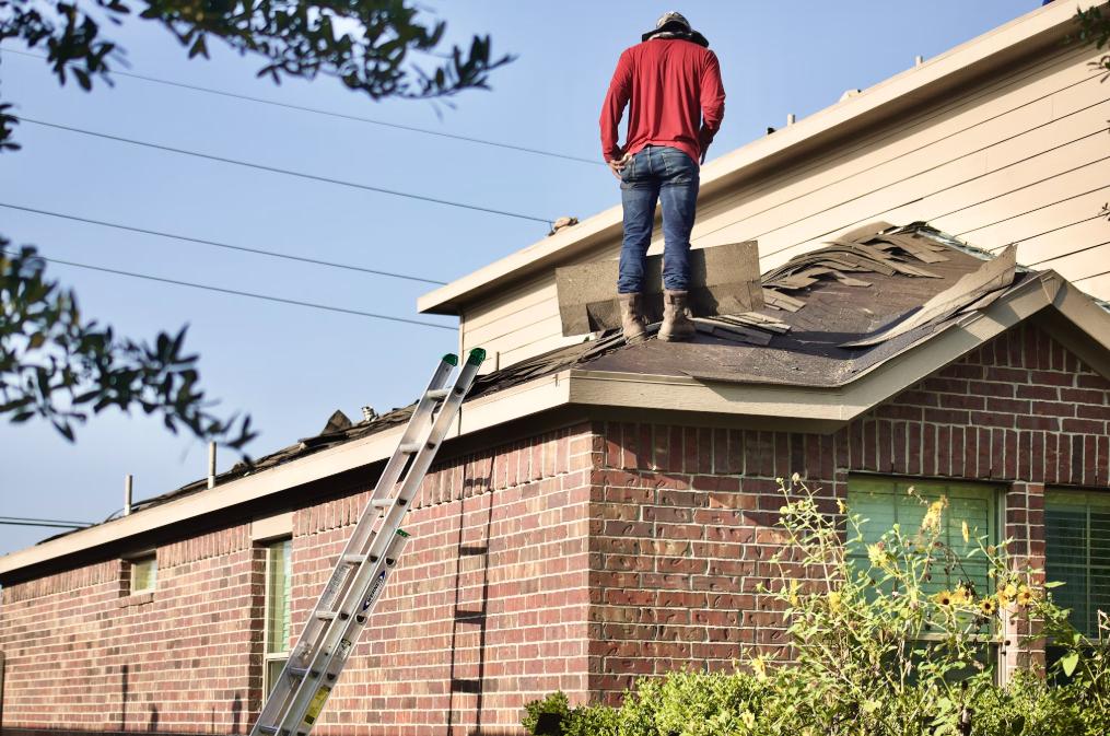 An expert providing shingle roofing for an older home.