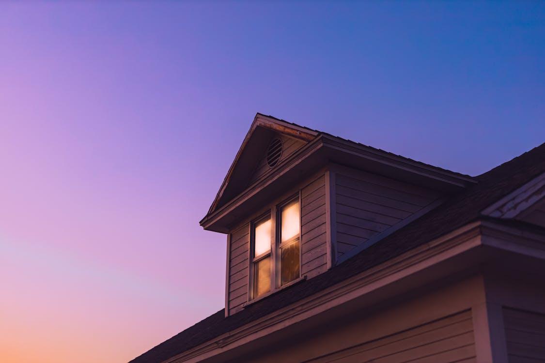 An image of the roof of a home during sunset 