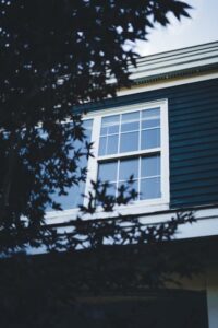 An image of a home with black paint and large windows  