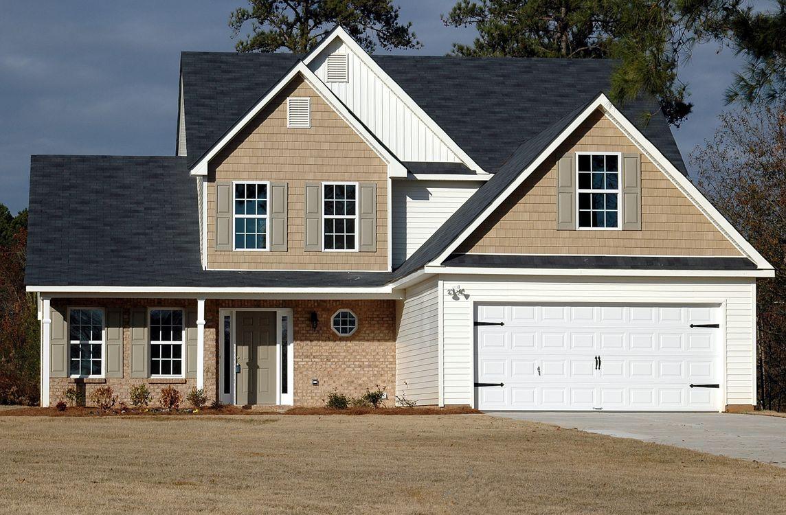 An image of a house with a white garage door
