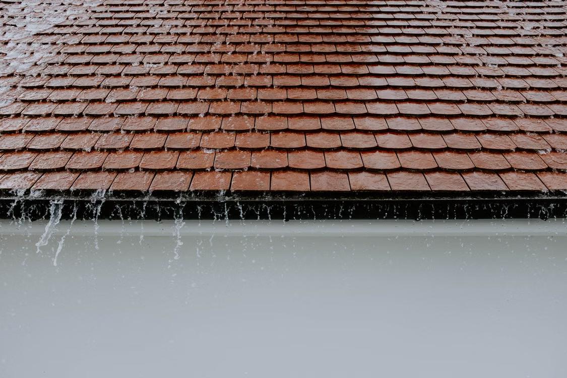 A residential roof during rainfall