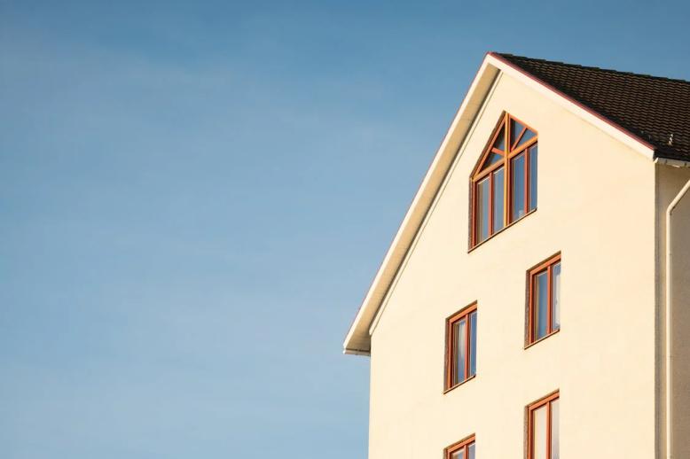 An image of a beige concrete house during the day   
