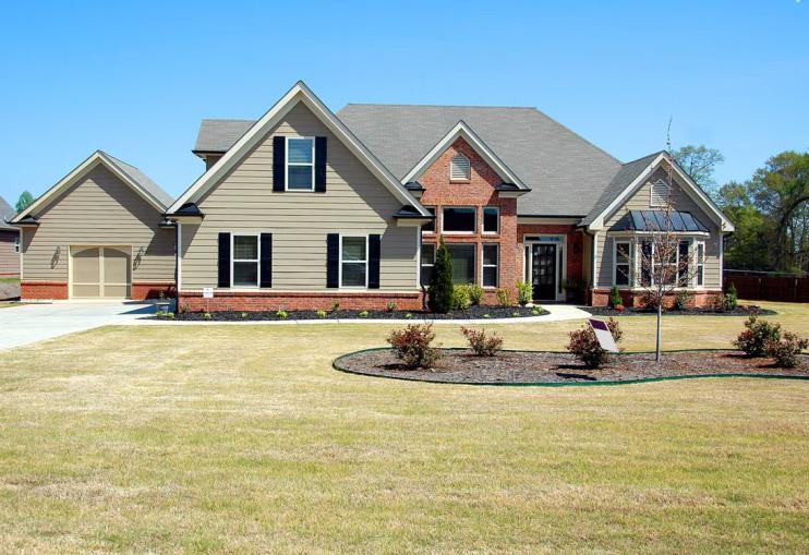 This photo shows a house that is painted gray.