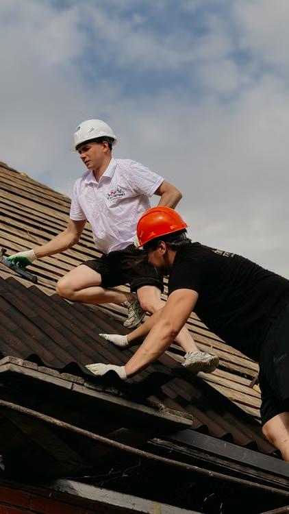 roofers repairing residential roof
