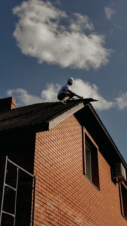 roofer repairing residential shingles