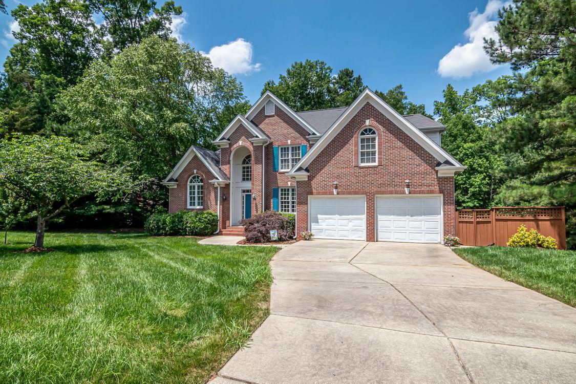 An image of a house with trees around it